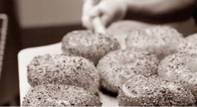 Sepia toned pallet of bagels with seeds